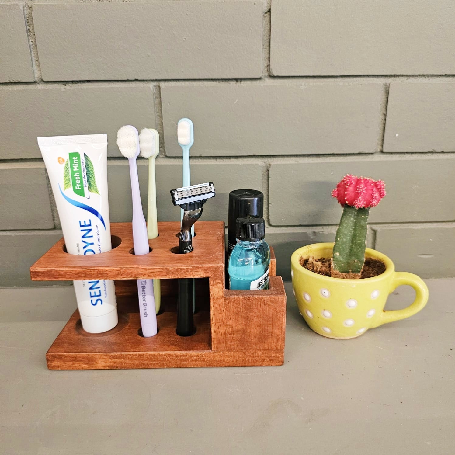 <img src="tooth-brush-holder.jpg" alt="Wooden toothbrush holder with a sleek design, perfect for organizing toothbrushes and keeping your bathroom tidy.">
