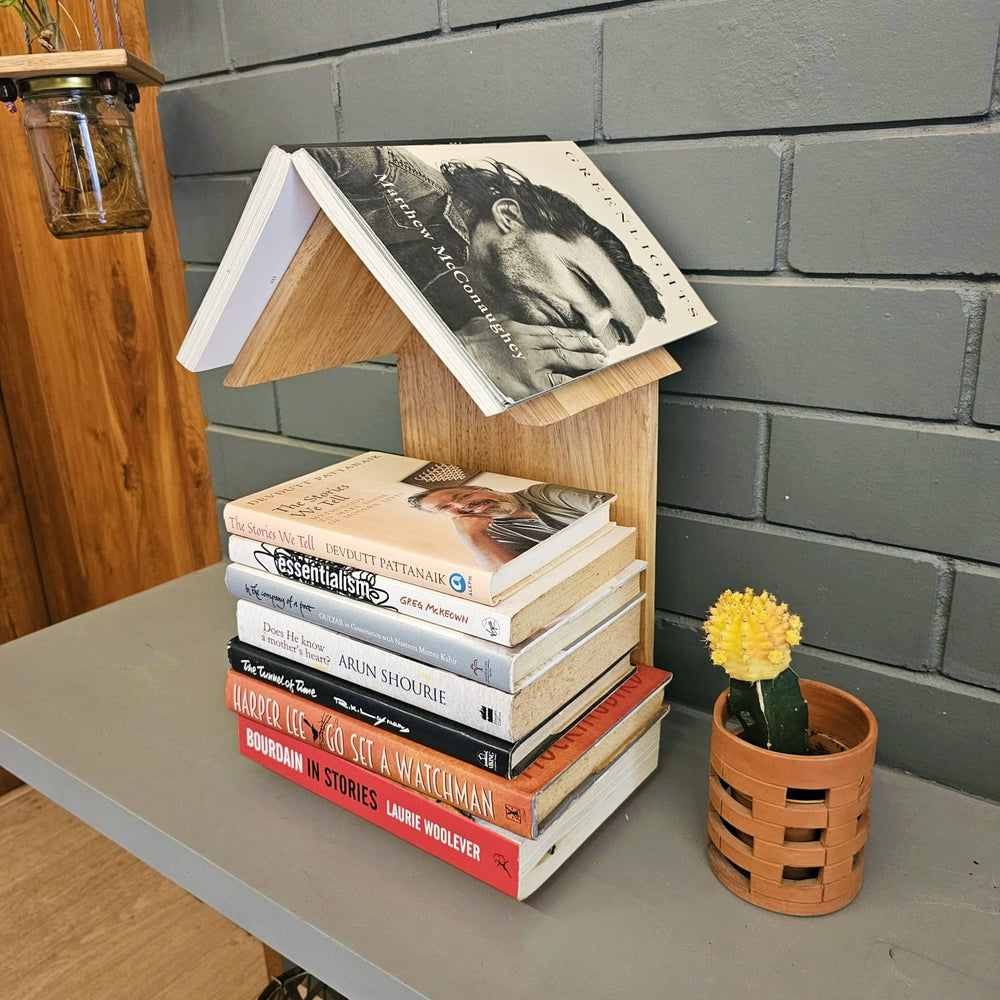 <img src="bedside-book-stand-table-top.jpg" alt="Bedside book stand for easy access to your favorite reads, with a sleek table-top design for a clutter-free space.">
