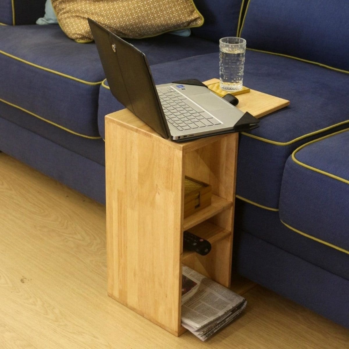 <img src="couch-caddy-1-centre.jpg" alt="Sofa table centre stand with space for your wine glass, offering both functionality and style to your living room.">