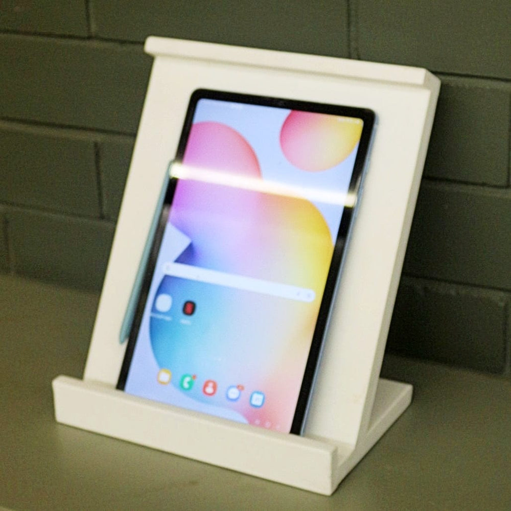 <img src="tablet-stand.jpg" alt="Tablet stand from Barish Home Decor, designed to hold tablets securely with a sleek and sturdy wooden frame.">